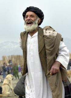 Kabul, afghanistan, march 9 2003 a fan shouts when watching dog fights that remain one of the chief attractions in kabul, the fights draw thousands of spectators, in case it wins, an asian sheepdog ma...