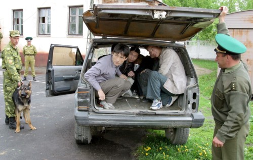 Caption: tas 27, belarus, may 12, 2003, a group of illegal immigrants from china (in picture) was detained by belarus border guards not far from the belarussian-ukrainian frontier , (photo itar-tass/ ...