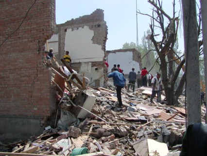 Chechnya, russia, may 12, 2003, people pictured clearing the debris in the village of znamenskoye where a powerful explosion ruined the buildings that housed the district administration ,on monday , m...