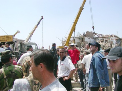 Caption: tas22, chechnya, russia, may 13, 2003, people pictured clearing the debris in the village of znamenskoye where a powerful explosion ruined the buildings that housed the district administratio...