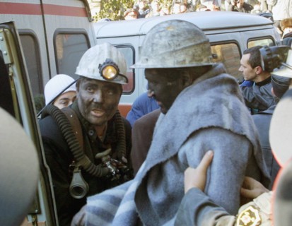 Rostov region, russia, october 29, 2003, one of the miners (r) found in the blocked mine today and a rescue worker (l), eleven miners out of 13 who spent 6 days in the blocked 'zapadnaya' mine were sa...