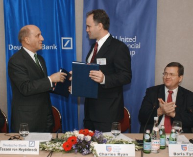 Tessen von heydebreck (deutsch bank ag) (l) and charles rhine (united financial group) exchanging documents during signing buisness cooperation agreement in hotel 'balchug-kempinsky' on thursday,  bor...