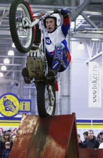 Dirt bikers demonstrate their skills at 'moscow international motor-park-2004' at crocus expo center, moscow, russia, 2004.