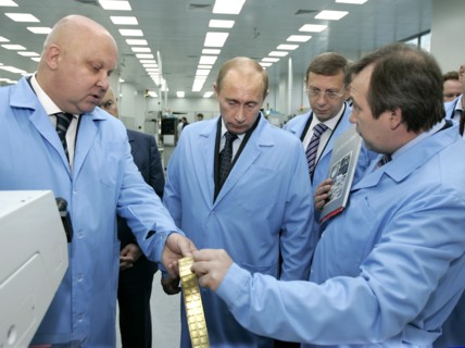 President of joint stock financial corporation sistema alexander goncharuk, left, russian president vladimir putin, center, and 'nllme and mikron' company general director gennady krasnikov, right, ta...