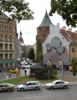 Smilsu street, a business area in old riga, latvia, the powder tower (r) and the dom cathedral (in the background), the coins depicted on the right part of the building are lats, the modern latvian cu...