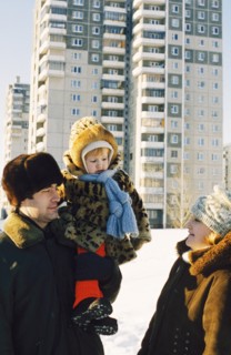 Young teachers with their child outside of new accomdations in chelyabinsk, russia.
