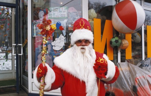 A man dressed as ded moroz (grandfather frost) selling christmas trinkets in moscow, russia.