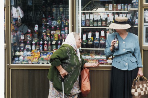 A woman beggar by a kiosk on a moscow street, august 1999.