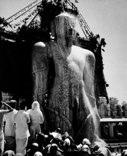 The gigantic statue of jain Gomateshvara Bahubali being bath in milk during the mahamastakabhisheka (the great anointing) festival