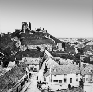 A black and white historic image of a city with a landmark on a hilltop