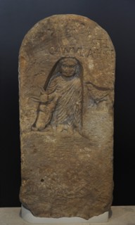 Roman funerary stele dedicated to a deceased girl, depicted in a niche with a full-length tunic and a cloak