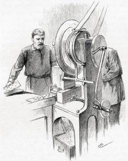 Workers using machines to punch out the blank coin, the Royal Mint, London,