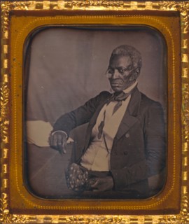 John Hanson, three-quarter length portrait, three-quarters view, wearing glasses, seated at desk