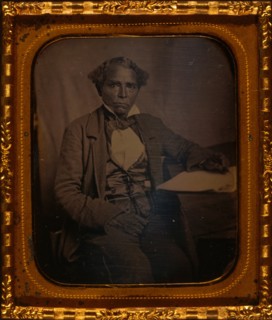 Edward Morris, three-quarter length portrait, full face, seated at desk
