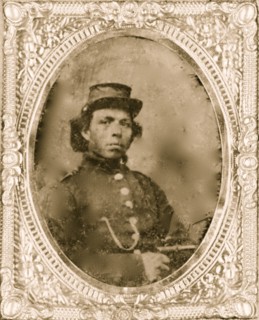 Black soldier seated with pistol in hand, watch chain in pocket