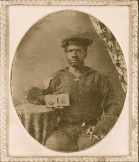 Sailor with cigar in hand holding a double case image of confederate soldiers