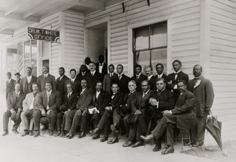 Booker T. Washington seated with group of men