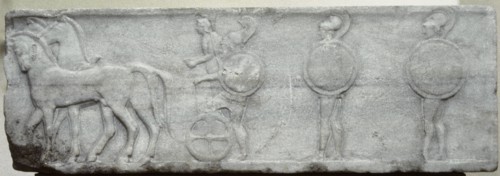 Base of funerary Kouros. Four-horse chariot and hoplites.