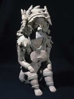 Male figure sitting.