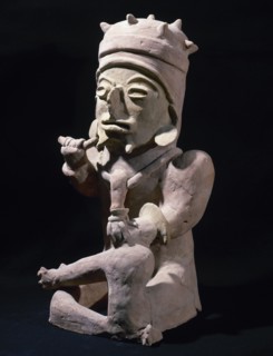 Male figure sitting cross-legged and hands objects.