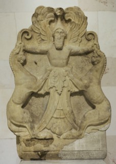 Acroterium with a relief depicting Arimaspian (winged-deity) holding griffins by their horns.