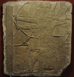 Assyrian warriors attacking an enemy city.