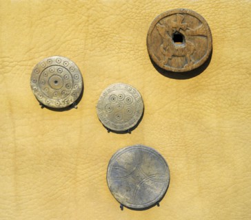 Probably from a popular board game in Europe, called Alquerque. Bone and wood.