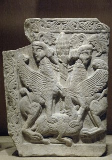 Tree of life between two sphinxes treading a deer.