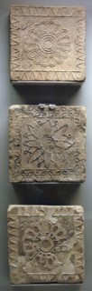 Terracotta tiles decorated in floral motifs.