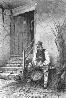 Wicker sits in front of his house and wilts a wicker basket  /  Korbflechter sitzt vor seinem Haus und flechtet einen Weidenkorb
