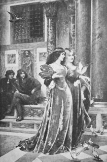 Two young women playing with the pigeons of St. Mark