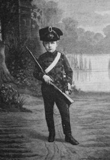 The emperor's oldest great-grandson in his first military uniform with rifle