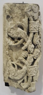 Arch segment with dragon and human head.