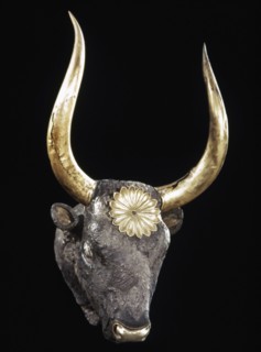 Silver rhyton in the shape of a bovine head, gold horns and rosette.