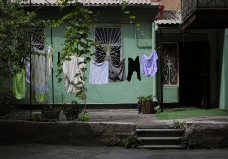 Interior of a typical yard of a house with laundry clothes drying.