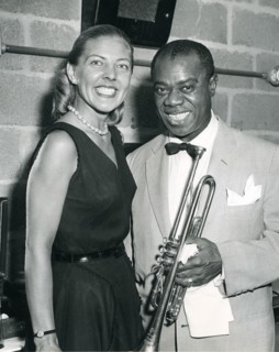 Louis 'Satchmo' Armstrong plays his trumpet in front of a Voice of American microphone. Armstrong is a leading good will ambassador through his music. Washington, DC, 1960.