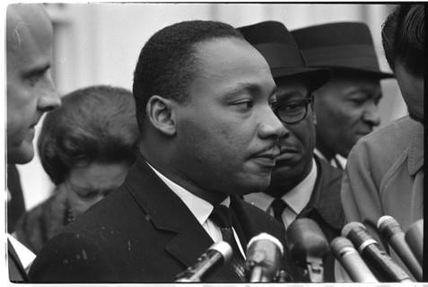 Martin Luther King, Jr. at microphones after meeting with President Johnson to discuss civil rights at the White House, Washington, DC, 1963. Photo by Warren K. Leffler.