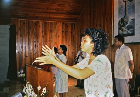 (R) Woman singing during a worship service in a small church in Honduras circa 1987.