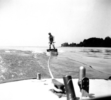 Man skiing behind a boat on a board circa 1930s.