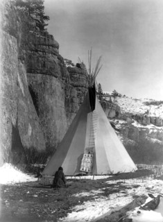 Edward S. Curtis Native American Indians - Apsaroke woman stretching hide that has been secured to the ground by stakes circa 1908.