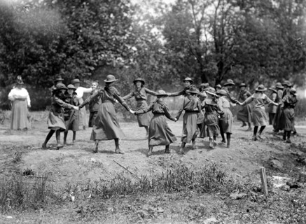 A group of Girl Scouts playing circa 1917 (possibly ring around the rosie) (Ring a Ring o' Rosie).