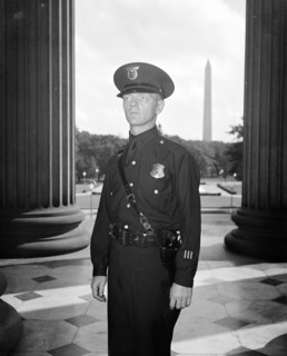 A U.S. Treasury Guard is displaying a new uniform for Treasury Officers circa 1937.