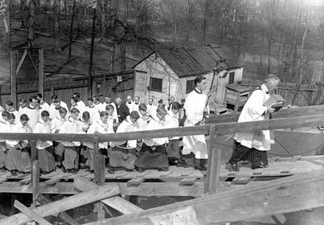 Catholic clergy and priests at outdoor religious service circa 1918.