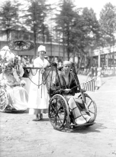 Wounded WW I soldiers at Walter Reed Hospital participate in a 4th of July wheel chair parade circa 1919 .