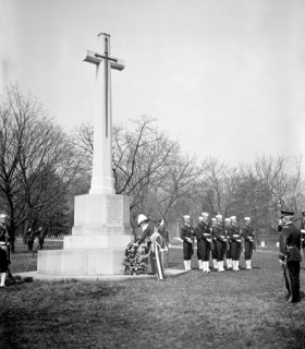 Canada's Governor General, Lord Tweedsmuir, placing a wreath on the Canadian cross in Arlington National Cemetery today circa 1937.