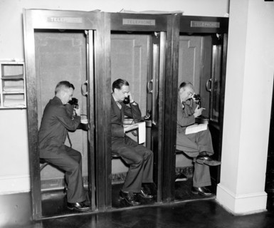 Reporters in White House press room calling in their stories to newspaper editors  circa 1937.