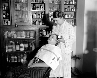 The department of Agriculture is making tests everyday in order to get cosmetics under the Pure Food and Drug Act, Mrs. C.W. West seated is helping Mrs. R. Goodman make a test on cold cream and other ...