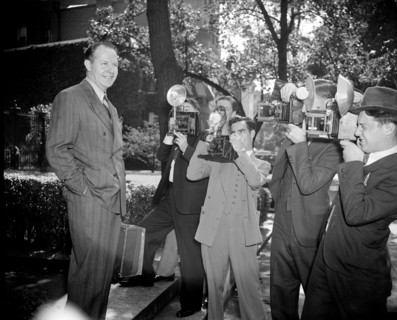 News photographers taking picture of Jimmy Mattern, noted flyer, leaving the Soviet Embassy today after reporting on his search for the six Russian Polar Flyers lost far above the Arctic Circle circa ...