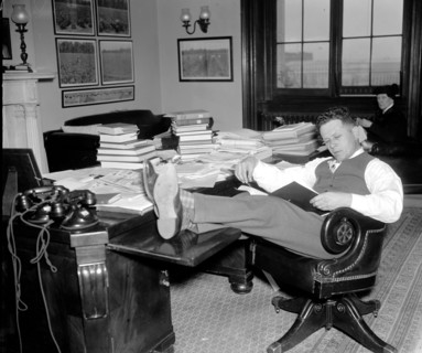 1/26/1938 - Democrat Senator Allen J. Ellender, of Louisiana, rests and studies up on Senate procedure of filibuster while his colleagues continue the Filibuster against the anti-lynching bill circa 1...