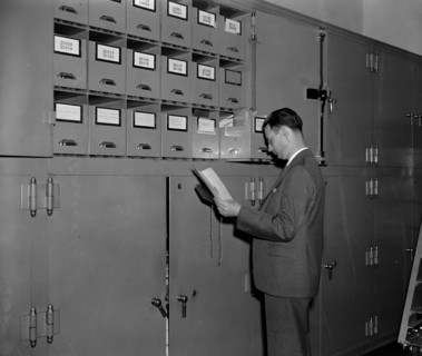 Secret Service agent at cabinet full of confiscated currency awaiting disposition, court trials, etc. circa 1938.